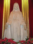 Statue of the Blessed Virgin Mary decorated with poinsettias at the The Lourdes Center in Kenmore Square