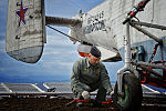 A naval crewman inspecting a Kamov Ka-27 helicopter