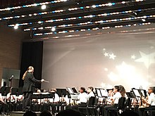 Conductor leads band students onstage