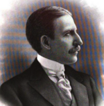 sideview portrait of well dressed man with mustache
