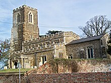 A photograph of All Saints Church taken from Sutton High Street