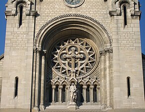 Rose window and statue of the Virgin Mary above the central portal