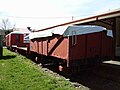 La Class open wagon, two N Class flat wagons, and a guard's van sit in the yard at Little River on a small section of track.