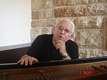 Moshe Zorman sitting in front of his piano