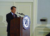 Chen Ding-nan, Minister of Justice of the Republic of China (Taiwan) delivering a speech in front of a lectern holding the logo of "The National Association of Attorneys General" (NAAG), during his visit lasting from 9–13 July 2002.