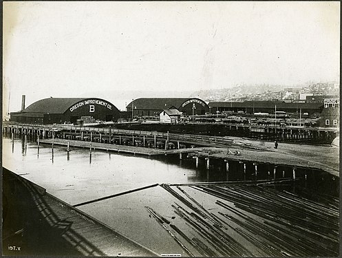 From the land side, circa 1890, showing the Oregon Improvement Company's post-Fire piers "B" (left) and "A" (right)