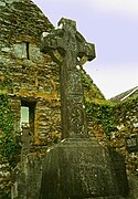 High cross with Gobnait's Abbey in background.