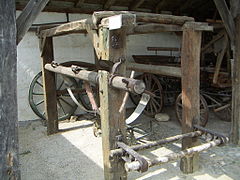 Ox shoeing sling in the Dorfmuseum of Mönchhof, Austria; a pair of ox shoes is attached to the near left column