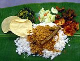 L-26 Description: A rice-based South Indian meal on banana leaf