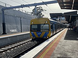 Comeng 614M on an up Craigieburn service towards Flinders Street arrives at Glenroy station Platform 1.