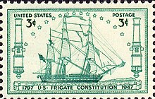 A postage stamp depicts Constitution at sail. The ship sails to the right side of the stamp.