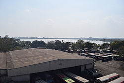 Hussain Sagar as seen from James Street railway station in Hyderabad, India. Seen in the foreground is Ranigunj Bus Depot.