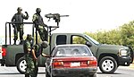 墨西哥毒品战争中在检查站执勤的墨西哥士兵的武装改装车上安装了Mk 19自动榴弹发射器。