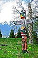 Totem poles with North Shore mountains in the background