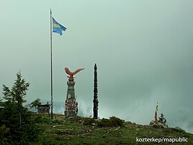 Turul statue with a Székely flag near at the peak of the Madarasi-Hargita (Harghita-Mădăraș), the holy mountain of the Székelys in Transylvania, Romania