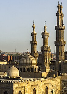 Exterior view of al-Azhar Mosque. Four minarets and three domes visible