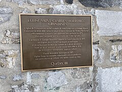 Commemorative plaque on the façade of the church