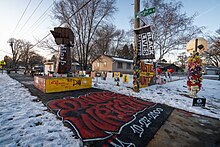 A memorial for Daunte Wright featuring artwork, signs, and messages about Wright and in support of the Black Lives Matter movement