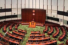 Large, round room with desks and a dais