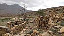 Yinainir - Stone constructions - Semi abandoned. In the background, the Jabal Yabanah with its two peaks