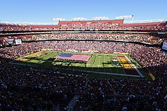 In-stadium pre-game photo of Northwest Stadium showing a large American flag