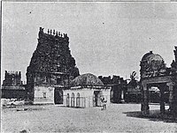 courtyard of a temple with towers in the background