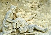 The soldier is mortally wounded and sits dreaming of his home, including the bell-tower of Marquéglise church which we see in the sculptor's relief.
