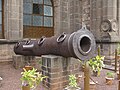 Historical cannon displayed in front of Gol Gumbaz