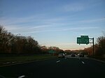 Signage denoting the State Senator Norman J. Levy Memorial Parkway designation just south of exit M7E on the northbound Meadowbrook