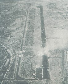 Aerial photo of smoke rising from an airstrip