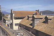 School House (two story building in the middle) and the Electric Repair shop (foreground) of Alcatraz. The buildings were built in the 1930's.