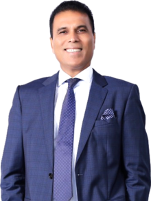 Colour photo headshot of Bikram Pandey wearing a blue suit with a white shirt and blue tie