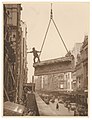 Building labourer on a stone being hoisted up to building, Pitt St, Sydney, c. 1930s. Photo by Sam Hood.