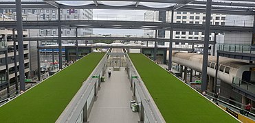 Shuttle Transit station at North Terminal in 2019 showing centre platform, platform doors and green roofs over tracks