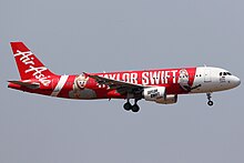 An airplane with the text "TAYLOR SWIFT" and headshots of her on its livery.