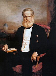 Painted portrait of bearded man in formal dress seated in an armchair with his left hand turning a page of an open book