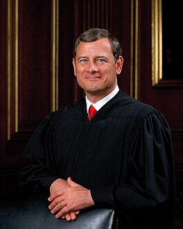 A man stands in judicial attire