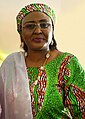 Aisha Buhari wearing Hausa clothes and hijab, which consists of the kallabi matching the dress cloth design, and gyale draped over the shoulder or front