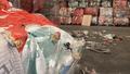 Soft plastic stockpiles and waste on the ground of a REDcycle warehouse