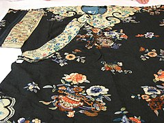 Chinese long robe with cloud collar motif.