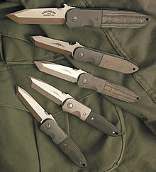 Five tanto-bladed folding knives showing subtle differences in blade geometry.