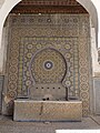 A wall fountain covered in zellij (mosaic tilework) in the second courtyard