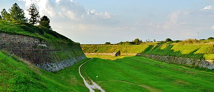 A stone wall set into the hillside surrounding Palmanova