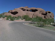 The Hole-in-the-Rock is a Phoenix landmark located in Papgo Park. It is a series of openings (tafoni) eroded in a small hill composed of bare red arkosic conglomeritic sandstone. The sandstone was first formed some 6-15 million years ago from the accumulation of materials eroding from a Precambrian granite, long since eroded away.