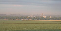 Town with grain elevators; crop field in foreground