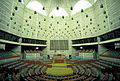 Image 68Jatiyo Sangsad Bhaban is the National Assembly Building of Bangladesh, located in the capital Dhaka. It was created by architect Louis I. Kahn and is one of the largest legislative complexes in the world. It houses all parliamentary activities of Bangladesh. This photo offers a view of the assembly hall inside the parliament building Photo Credit: Rossi101