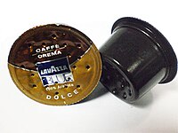 Used Lavazza BLUE coffee capsules, showing the puncture holes
