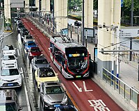 A trolleybus at a bus stop platform in Shanghai, China