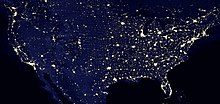 Nighttime satellite image of the contiguous United States showing light pollution in densely populated areas