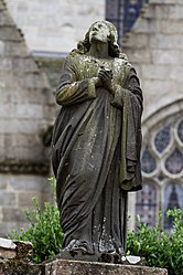 John the Evangelist looks up towards Jesus on the cross-The Larhantec calvary at Saint-Thégonnec